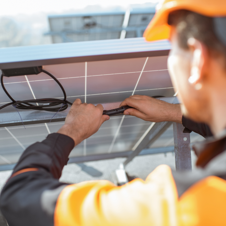 Technicien posant des panneaux photovoltaïques sur une toiture